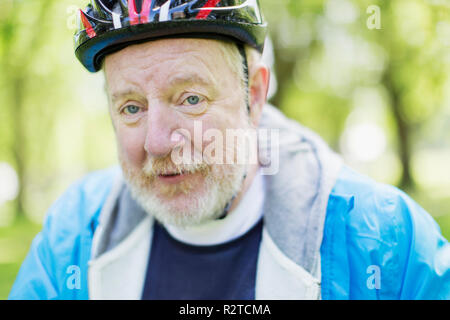 Portrait confident active senior man wearing bicycle helmet