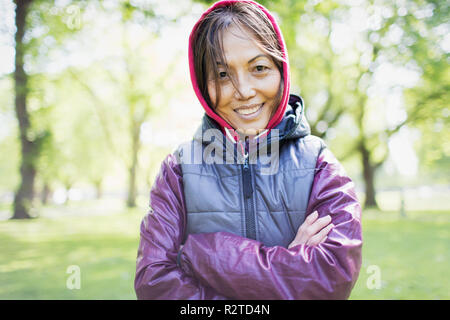 Portrait smiling, confident active senior woman in park Stock Photo