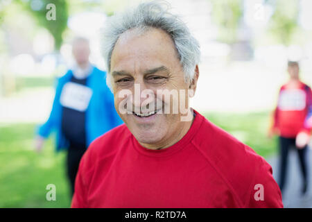 Fitness, exercise and portrait of a sports man standing arms crossed  outdoor with a smile on