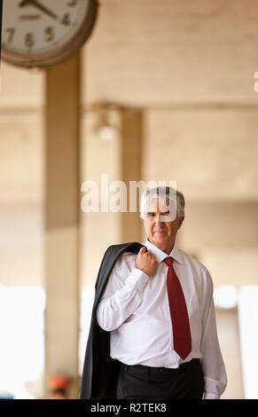 Senior businessman waiting in train station. Stock Photo