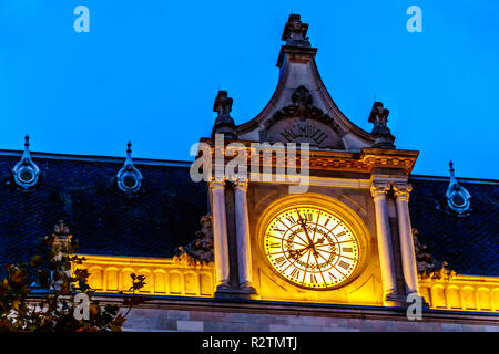 The lighted clock of Cercle Cité Luxembourg at night in the heart of the historic and touristic city of Luxembourg Stock Photo