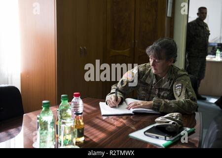 U.S. Army Brig. Gen. Marti Bissell, NATO Headquarters Sarajevo commander, signs a guest book while visiting Armed Forces of Bosnia and Herzegovina visiting 5th Infantry Brigade in Tuzla, BiH Oct. 30, 2018. NHQSa staff visited the brigade to meet the soldiers and their leadership, and to familiarize themselves with 5th Infantry Brigade's mission and capabilities. Stock Photo