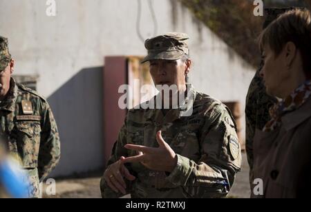 U.S. Army Brig. Gen. Marti Bissell, NATO Headquartes Sarajevo commander, speaks with Armed Forces of Bosnia and Herzegovina soldiers during a tour of a munitions storage site in Tuzla, BiH, Oct. 31, 2018. NHQSa staff visited military installations in the area to familiarize themselves with 5th Infantry Brigade's mission and capabilities. Stock Photo