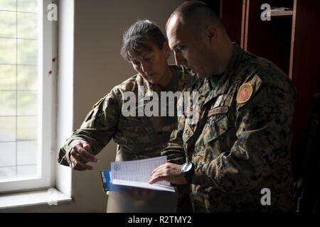 U.S. Army Brig. Gen. Marti Bissell, NATO Headquarters Sarajevo commander, and Armed Forces of Bosnia and Herzegovina Pukovnik Robert Gasic, 3rd Infantry Battalion commander, inspect a solider's booklet during a tour of 'Vojvoda Stepa Stepanovic' barracks in Bijeljina, BiH, Oct. 31, 2018. NHQSa staff visited military installations in the area to familiarize themselves with 5th Infantry Brigade's mission and capabilities. Stock Photo