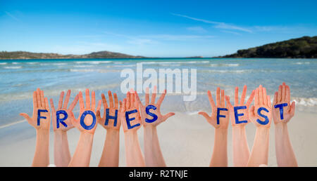 Many Hands Building Frohes Fest Means Merry Christmas, Beach And Ocean Stock Photo