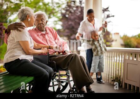 Senior man speaking with his wife on a porch. Stock Photo