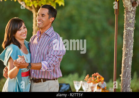 Smiling mid adult couple playfully dancing together. Stock Photo