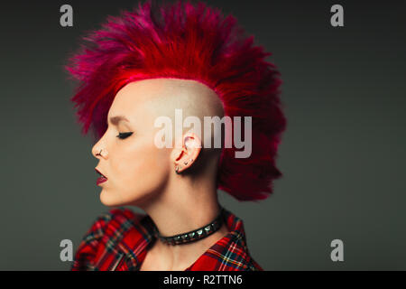 Profile portrait cool young woman with pink mohawk Stock Photo
