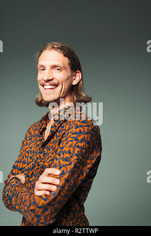 Portrait smiling, confident young man with handlebar mustache Stock Photo