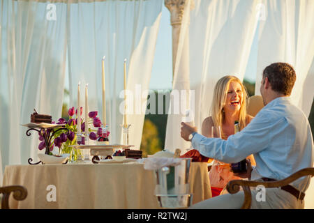 Smiling mid adult couple having a romantic dinner. Stock Photo