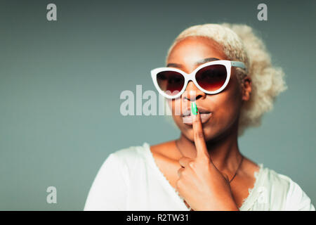 Portrait confident, cool young woman wearing retro sunglasses Stock Photo