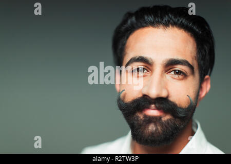 Portrait smiling, confident young man with handlebar handlebar mustache Stock Photo