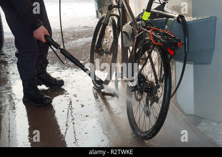 washing the bike, washing the bike with a hose under pressure Stock Photo