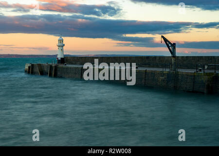 Mevagissey lighthouse has stood on the pier since 1896 and can be seen for 12 nautical miles. Stock Photo