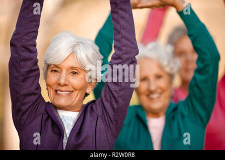 Portrait of three senior women doing yoga together. Stock Photo
