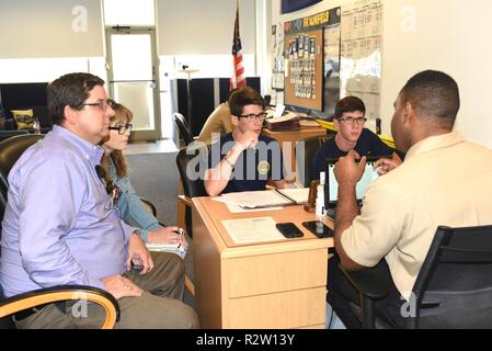 NEW BRAUNFELS, Texas – (October 30, 2018) Electronics Technician (Submarines) 1st Class Vincent Barnes of Chicago assigned to Navy Recruiting Station (NRS) New Braunfels, Navy Recruiting District (NRD) San Antonio, talks with twin brothers Jack and James Lanier of Universal City, Texas, during their 72-hour indoctrination process at the NRS along with their parents, Jim and Nicole Lanier.  The Lanier brothers are seniors at Marion High School in Marion, Texas, and joined the Navy in the Nuclear Propulsion Program which currently is awarding bonuses of up to $40,000.  Barnes is a graduate of Co Stock Photo