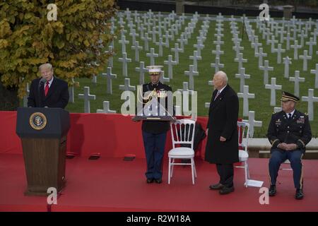 President Donald J. Trump presents an American flag to Secretary of the American Battle Monuments Commission, retired Maj. Gen. William M. Matz, at the Suresnes American Cemetery while honoring the centennial of Armistice Day, Paris, France, Nov. 11, 2018. The ceremony was held on the 100th anniversary of the Armistice that took place on the eleventh hour, of the eleventh day, of the eleventh month of 1918, marking the end of World War One. Stock Photo