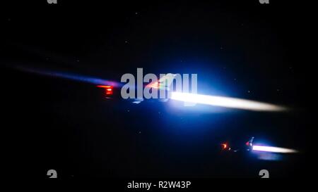 A pair of F-16 Fighting Falcons depart and light their afterburners after receiving fuel from a 28th Expeditionary Aerial Refueling Squadron KC-135 Stratotanker in support of Operation Inherent Resolve over Iraq, Nov. 8, 2018. The 28th EARS empowers the fight against ISIS by providing mission extending aerial refueling services to U.S. and Coalition forces conducting operations in OIR's area of responsibility. Stock Photo