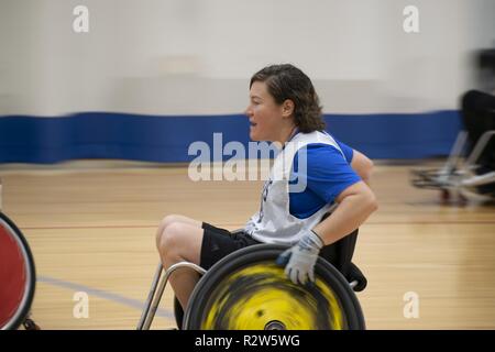 Retired Captain Kelly Patterson moves quickly up the court during wheelchair rugby practice at the NE Region Warrior CARE Event at Joint Base Andrews, MD. She competed at the 2017 Warrior Games and hopes to get on the Team US for Invictus Games in 2020. The biggest moving part of the AFW2 Warrior CARE Events is the adaptive sports. It's dynamic and fast-moving, giving each warrior an opportunity to see what they can do versus what they cannot. These wounded warriors often come to the events with a prescribed lists of things they cannot do and the coaching staff work hard to move around those m Stock Photo