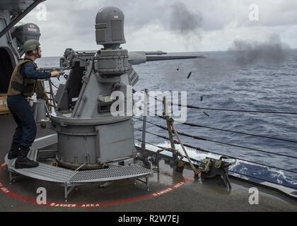 CARIBBEAN SEA (Nov 10, 2018) Gunner’s Mate seaman Thomas Mcneely locally fires a 25mm machine gun during a pre-aim calibration fire (PACFIRE).  Ramage is currently underway in the U.S. 4th Fleet area of responsibility in support of U.S. 4th Fleet tasking. Stock Photo