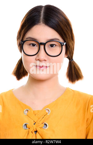 Face of young beautiful Asian woman wearing eyeglasses Stock Photo