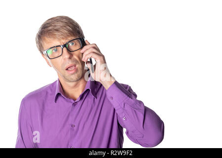 Amazed middle age man with glasses talking on the phone on white background Stock Photo