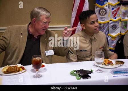 Ret. Lt. Gen. Jack Klimp, with the Beaufort Rotary Club, and Lance Cpl. Carlos Silva, with Headquarters and Service Battalion, Marine Corps Recruit Depot Parris Island, talk during a luncheon before an award ceremony Nov. 14, 2018 in Beaufort, S.C. Silva, from New York, N.Y., was awarded the “Beaufort Rotary Military Persons of the Year” award by the rotary club for being an outstanding Marine and volunteering in the local community. Stock Photo