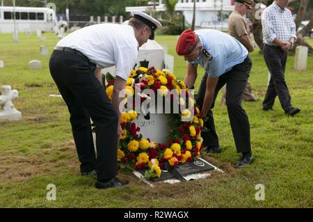 Hagåtña, Guam (Nov. 15, 2018) - Flag officers participating in a German capstone course place a wreath on the SMS Cormoran II headstone during a wreath laying ceremony at the U.S. Naval Cemetery in Hagȧtña Nov. 15. Seven Sailors aboard Cormoran II, a German naval ship docked in Guam’s Apra Harbor during World War I, lost their lives during an explosion and were buried at the cemetery. Stock Photo