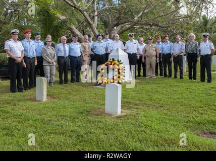 Hagåtña, Guam (Nov. 15, 2018) - German flag officers and civilian leadership participating in a German capstone course gather with U.S. military leadership for a photo following a wreath laying ceremony at the SMS Cormoran II headstone at the U.S. Naval Cemetery in Hagȧtña Nov. 15. Seven Sailors aboard Cormoran II, a German naval ship docked in Guam’s Apra Harbor during World War I, lost their lives during an explosion and were buried at the cemetery. Stock Photo