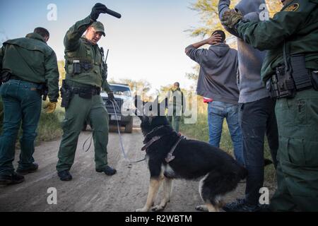 U.S. Border Patrol agents arrest illegal aliens attempting to enter the United States after crossing the Rio Grande River in McAllen, Texas on November 15, 2018. Stock Photo