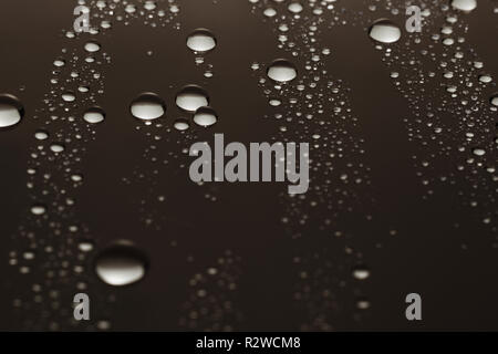 Drops of water on a dark glass texture background Stock Photo