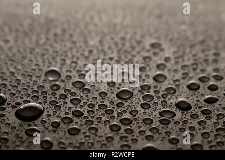 Drops of water on a dark glass texture background Stock Photo