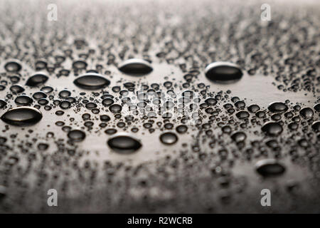 Drops of water on a dark glass texture background Stock Photo