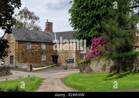 A view across the green to The Old Red Lion, a traditional village pub, Litchborough, Northamptonshire, UK Stock Photo