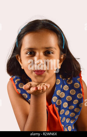 Little girl giving a flying kiss looking at camera. Pune, Maharashtra Stock Photo