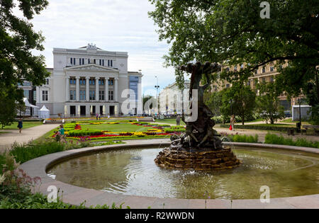 RIGA, Latvia - July 27, 2013: Latvian National Opera House and the fountain with a bronze statue in the foreground Stock Photo
