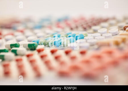 Many colorful medicines are sorted in blister packaging next to each other Stock Photo