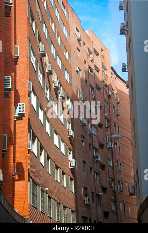 Orange brick building with concave wall, vertical view, summer Stock Photo