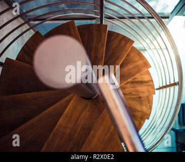 Modern wooden stairs with metal handrails Stock Photo