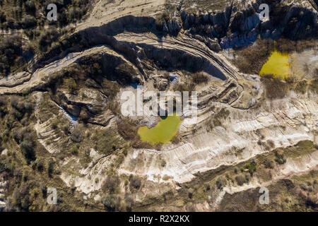 Industrial mining landscape from a drone. Aerial view of an abandoned open pit mine, nature pollution Stock Photo