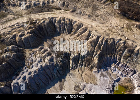 Industrial mining landscape from a drone. Aerial view of an abandoned open pit mine, nature pollution Stock Photo