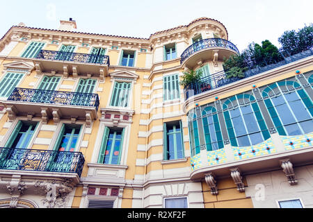 Interesting yellow house on the streets of Cannes. Garden on the roof. Colourful building. French architecture. Wide angle shot Stock Photo