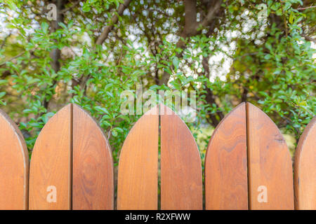 Countryside wooden fence background with blurred green garden Stock Photo