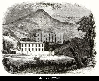 Solitary ancient rural house in a valley with a volcano in the background. Illustration in engraving style by unknown author, Magasin Pittoresque 1846 Stock Photo