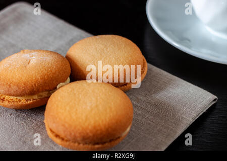 Chocolate covered biscuit heart shaped biscuit on a napkin Stock Photo