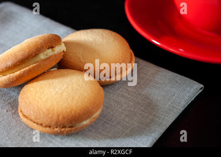 Chocolate covered biscuit heart shaped biscuit on a napkin Stock Photo