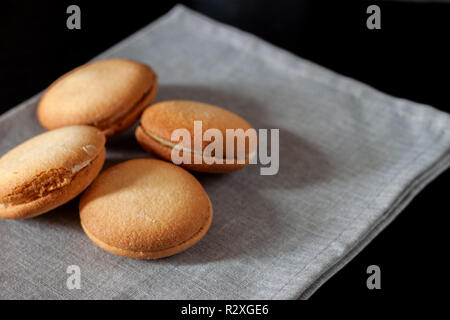 Chocolate covered biscuit heart shaped biscuit on a napkin Stock Photo