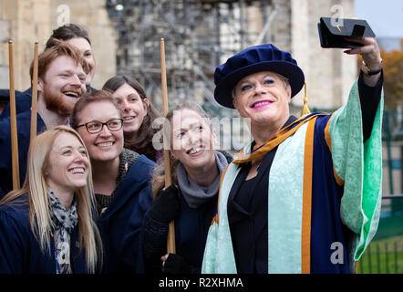 Eddie Izzard take a photograph with graduates after receiving an honorary degree from York St John University during a graduation award ceremony at York Minster. Stock Photo