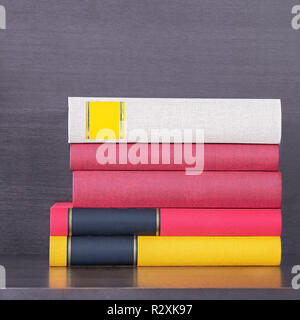 stack of new colorful books in the wooden bookself Stock Photo