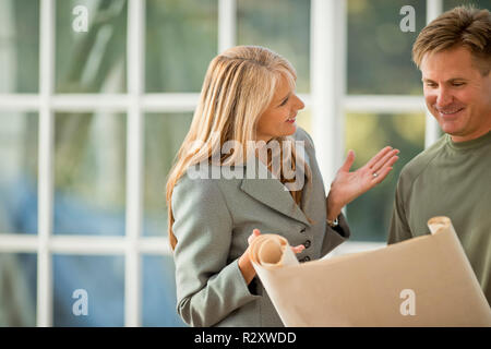 Businesswoman and contractor working together on a project. Stock Photo